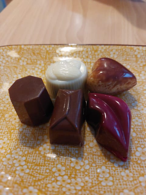 Bruges: Walking Tour with Hot Chocolate & Chocolate Tasting - Meet at FNAC and find your neon guide